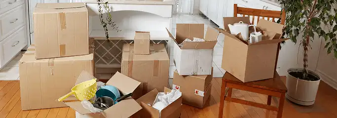 Packed moving boxes and household items in a kitchen before move-out or move-in cleaning, Raleigh, NC.
